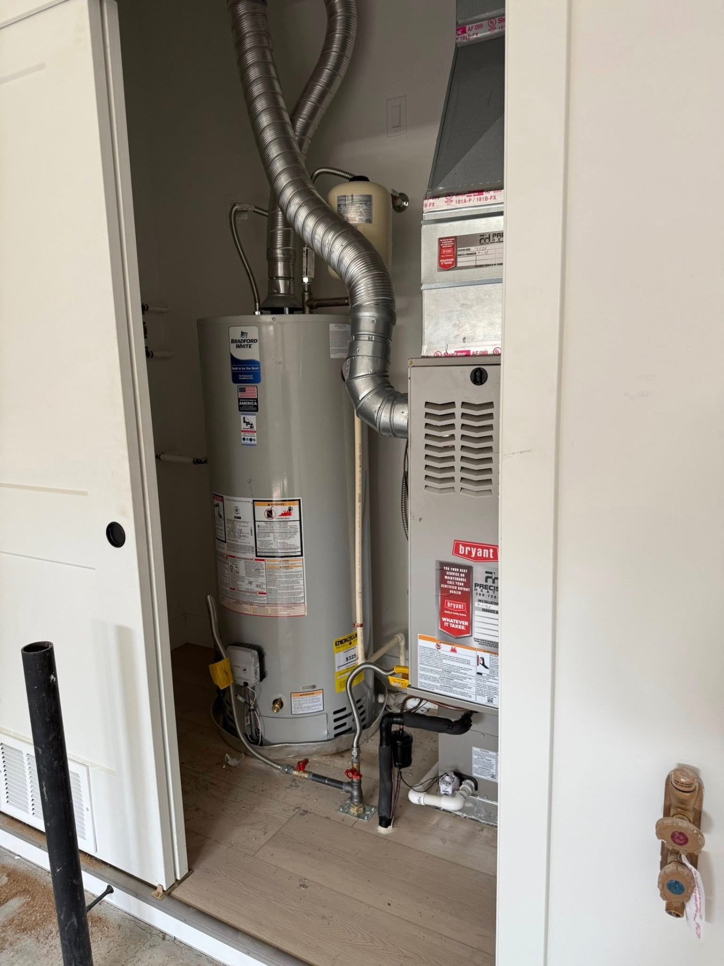 Mechanical room with Bradford White water heater and Bryant furnace install